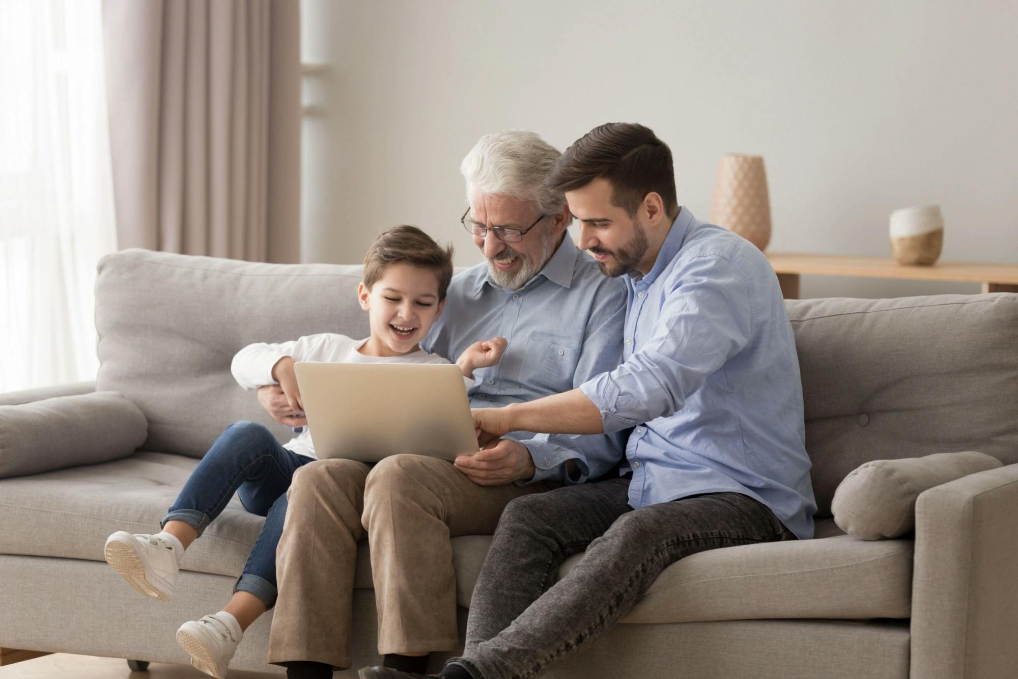 Grandfather, father, and son researching how to combine assets