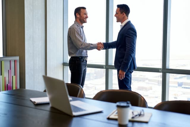 businessmen shaking hands after planning for a liquidity event in Houston