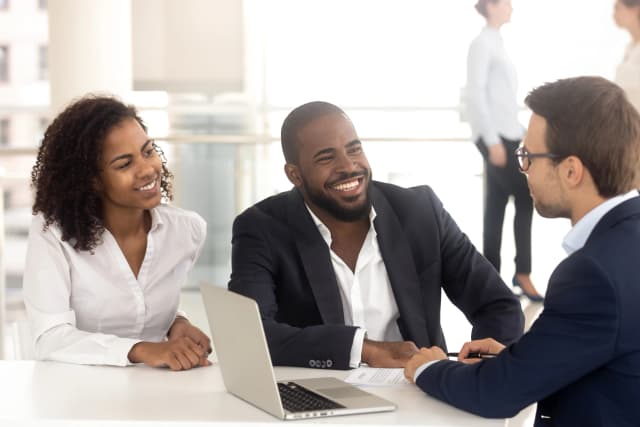 Family meeting with their financial manager and smiling