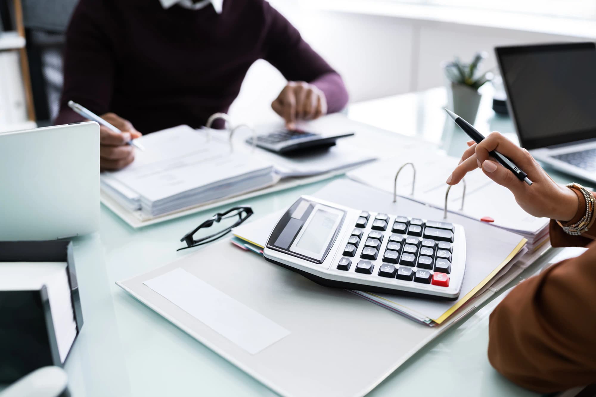 Two people at a desk working on complex tax issues.