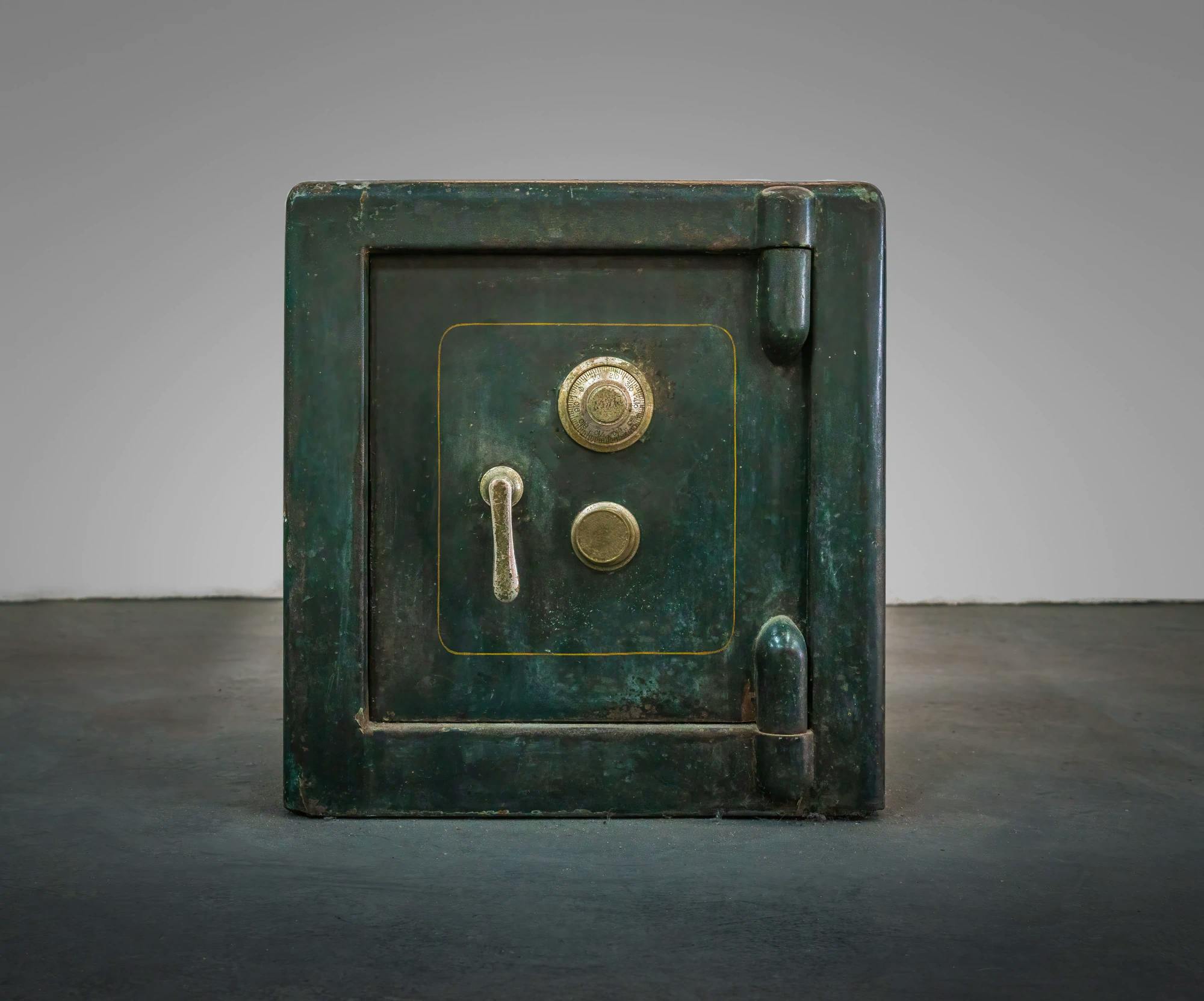 Large antique safe with a green patina.