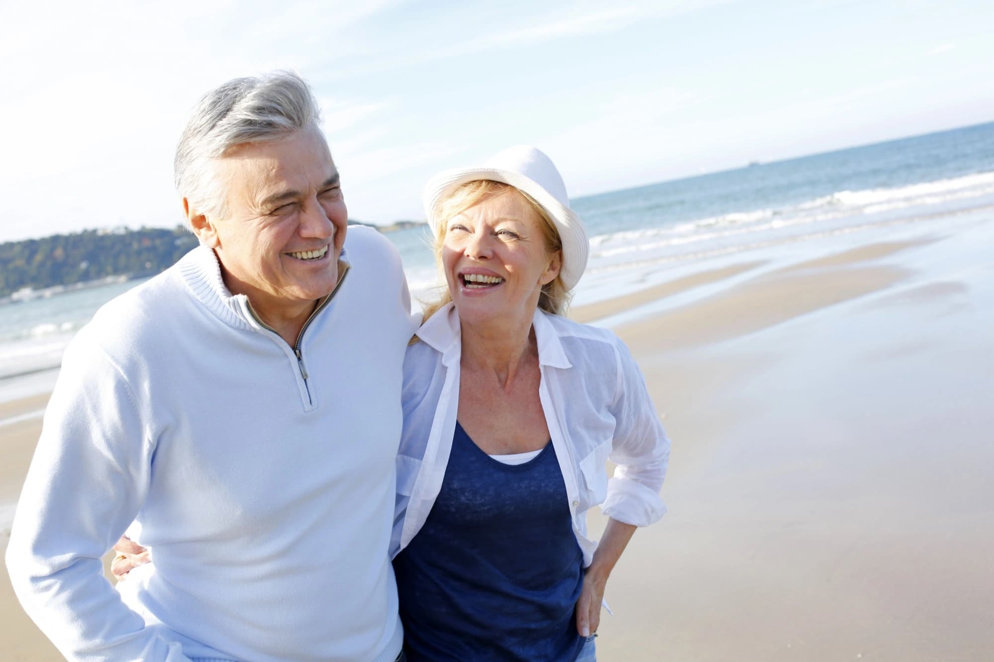 Senior, retired couple walking on the beach