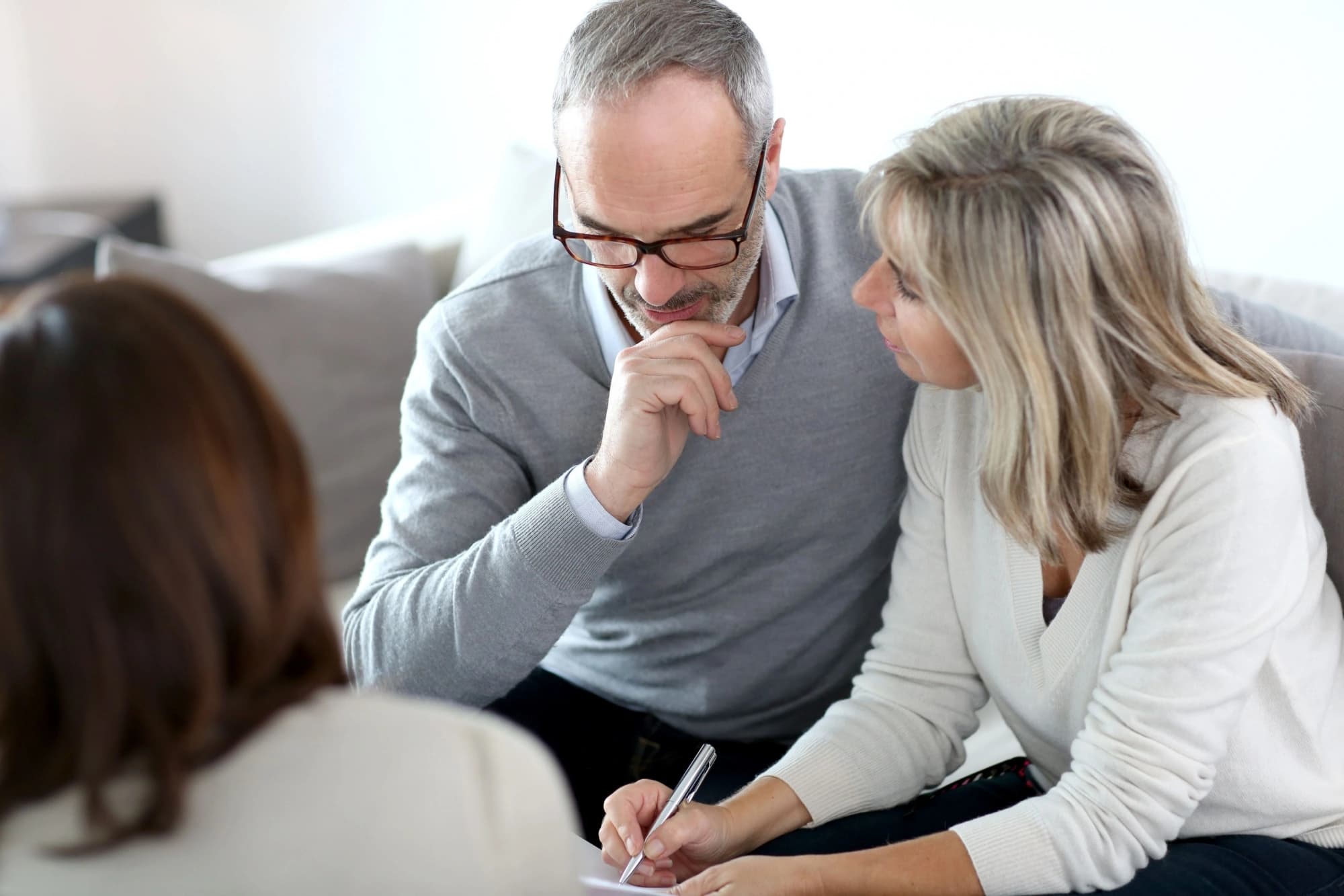 A high-net-worth couple discussing retirement plans with a wealth advisor