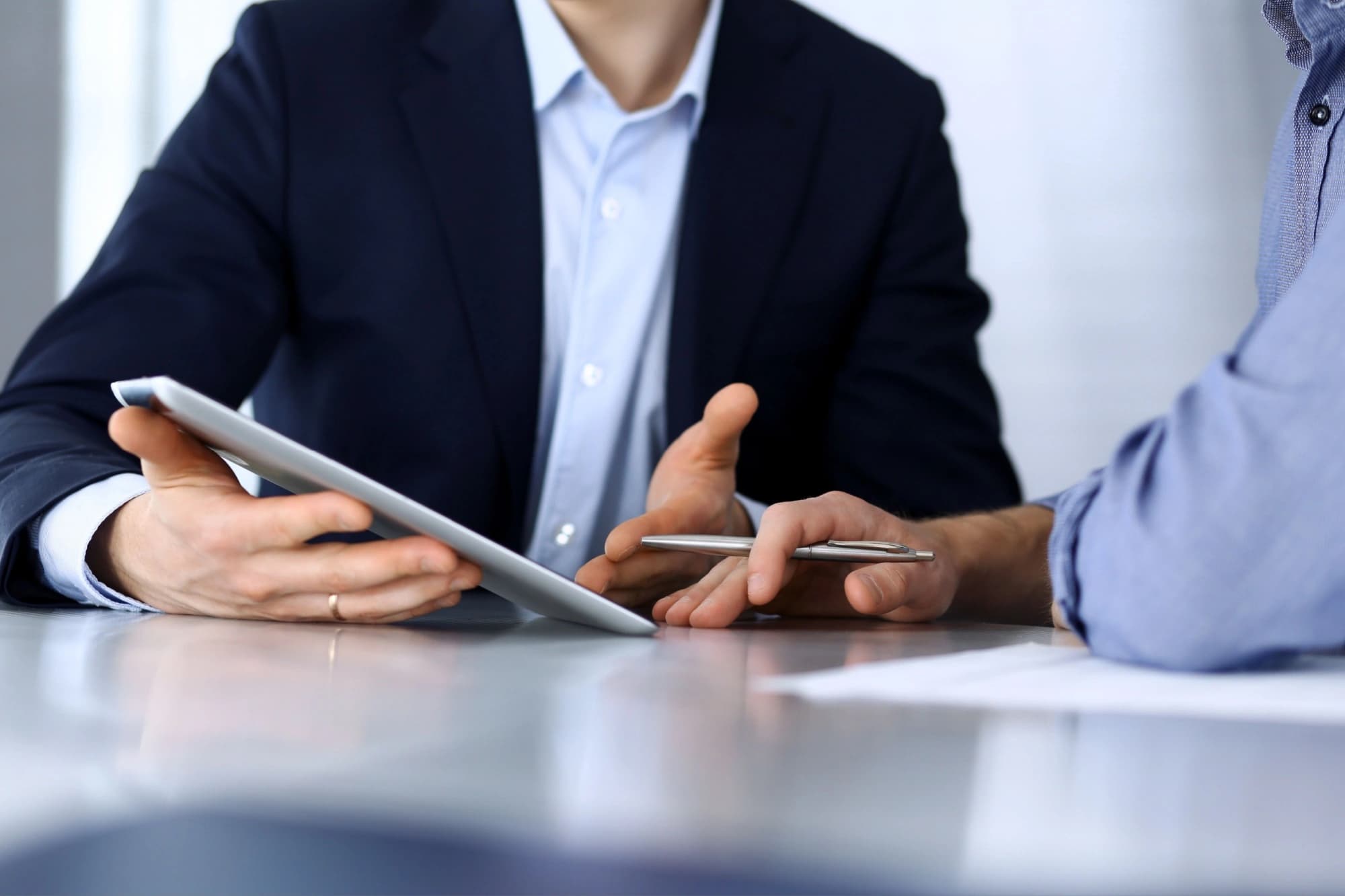 Investment manager showing client their asset allocation on a tablet