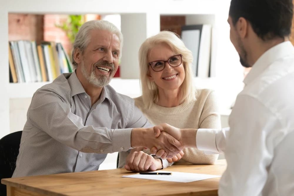 A high-net-worth couple planning their estate with their wealth advisor