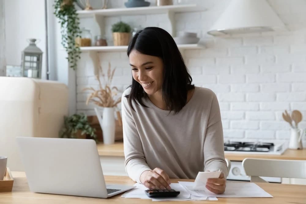 A woman reviewing her various investment accounts from her laptop