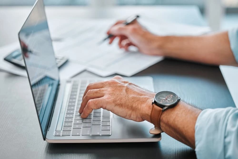 A tax planning professional at work on a laptop