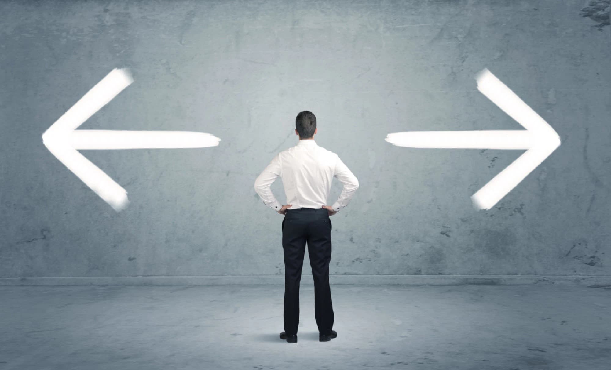 a businessman weighing two opposing options