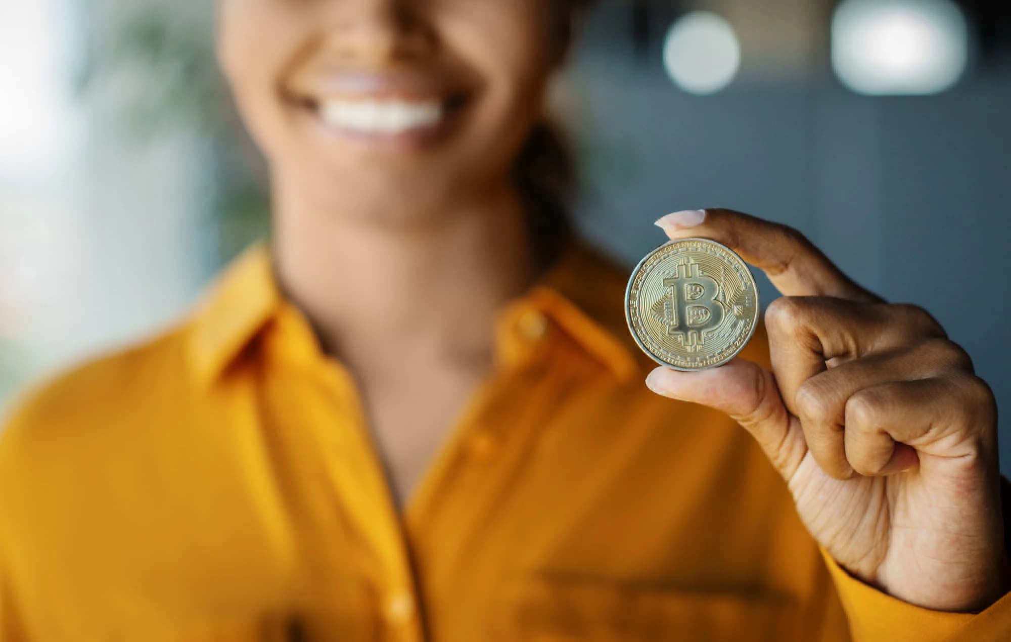 Woman holding a physical representation of Bitcoin