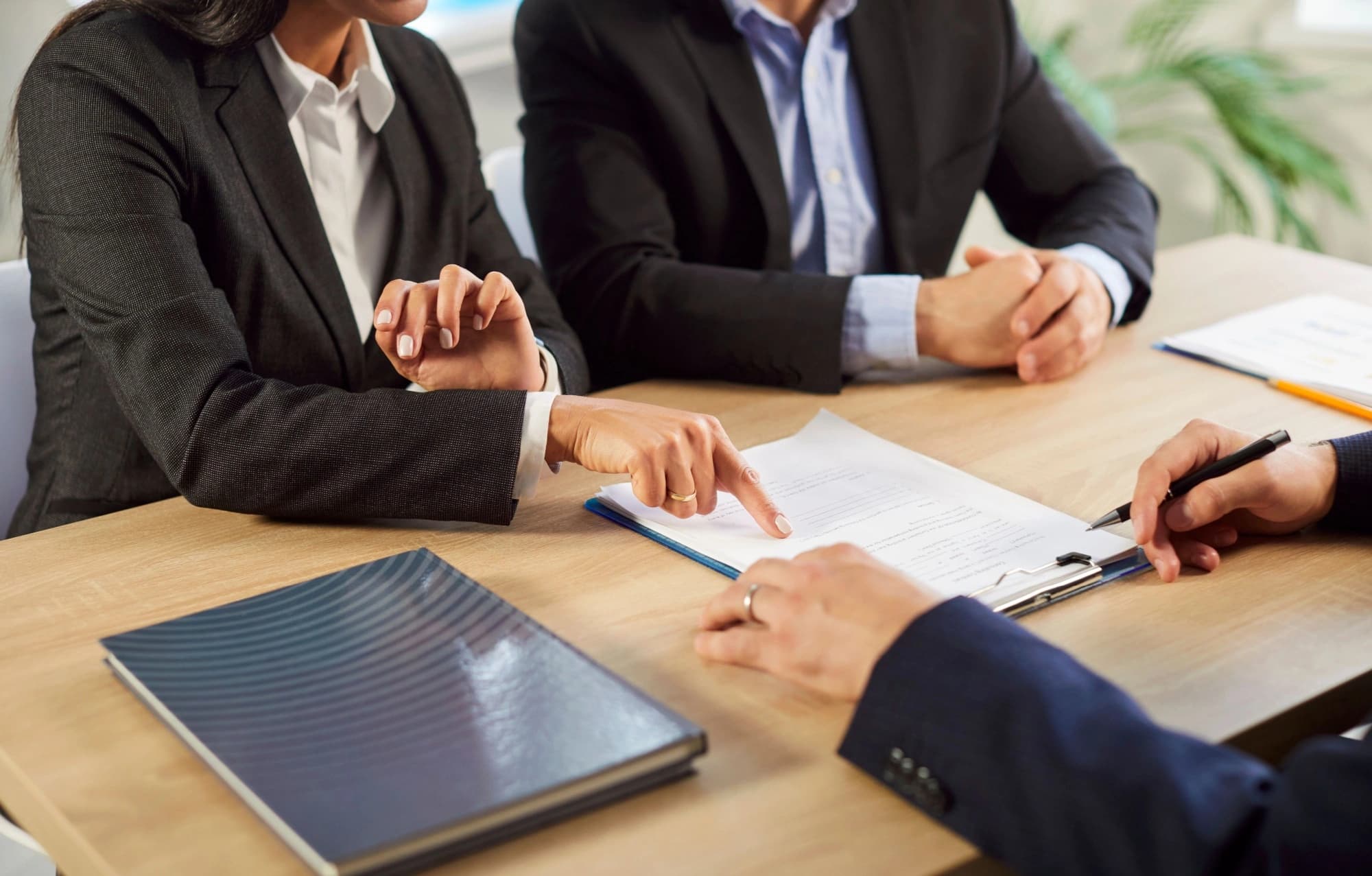 Cropped shot of two business clients signing a modified endowment contract