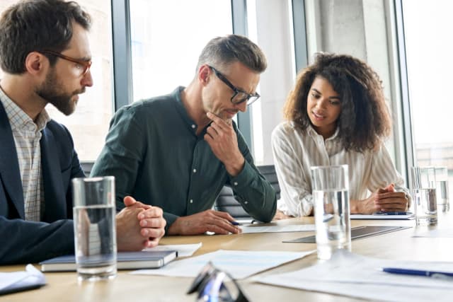 A high-net-worth business owner deciding with his colleagues.