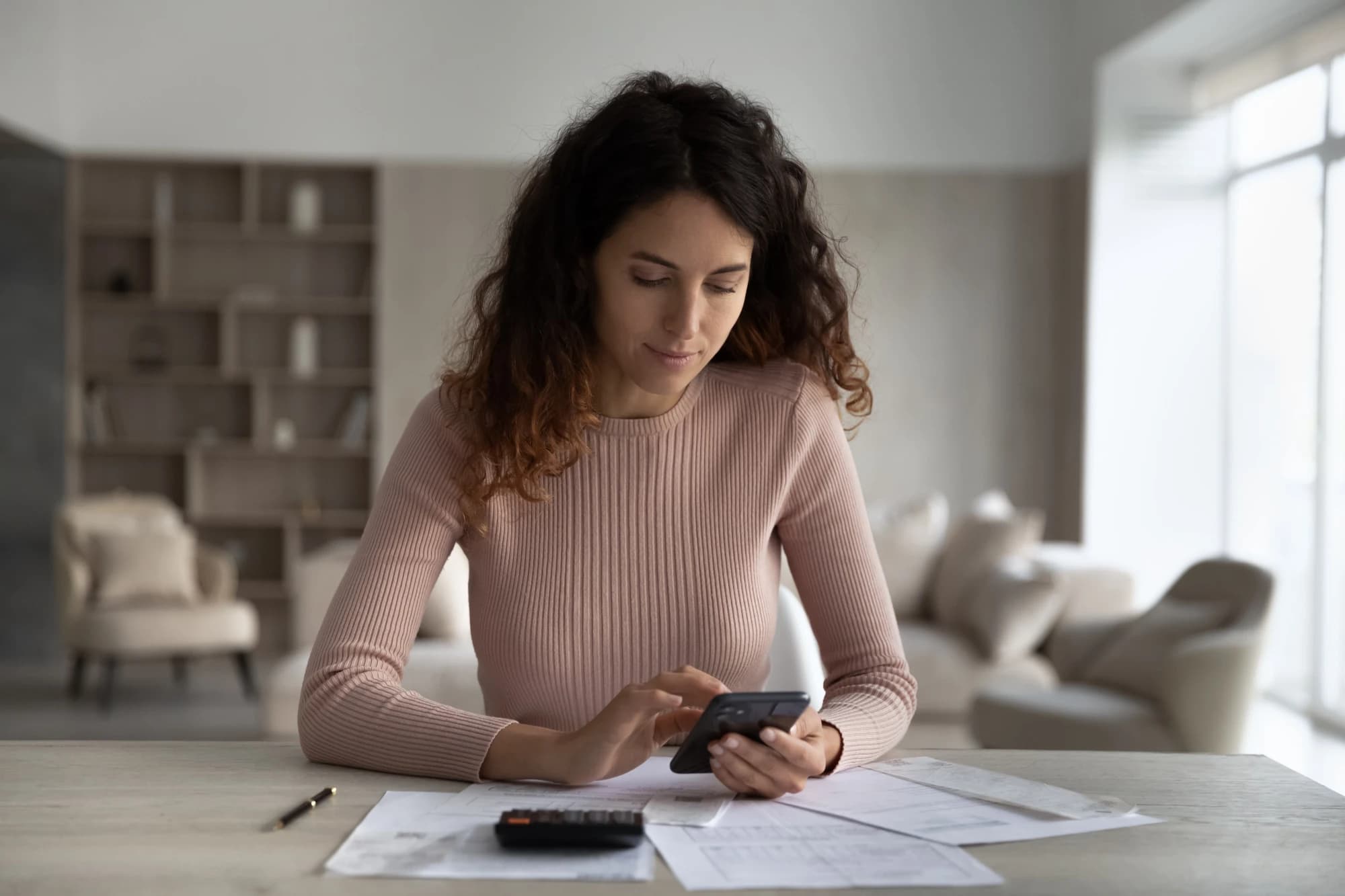 Latina woman looking at how much she has made in phantom income