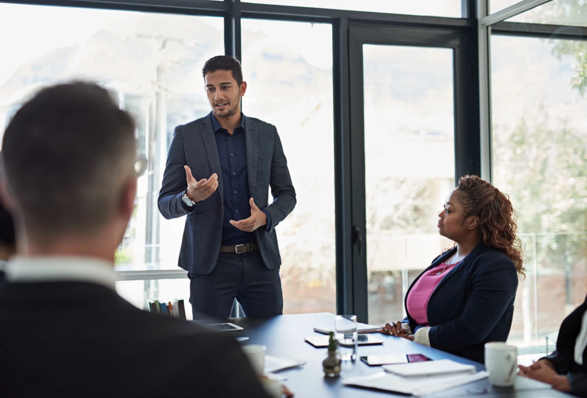 A young professional leading a business meeting