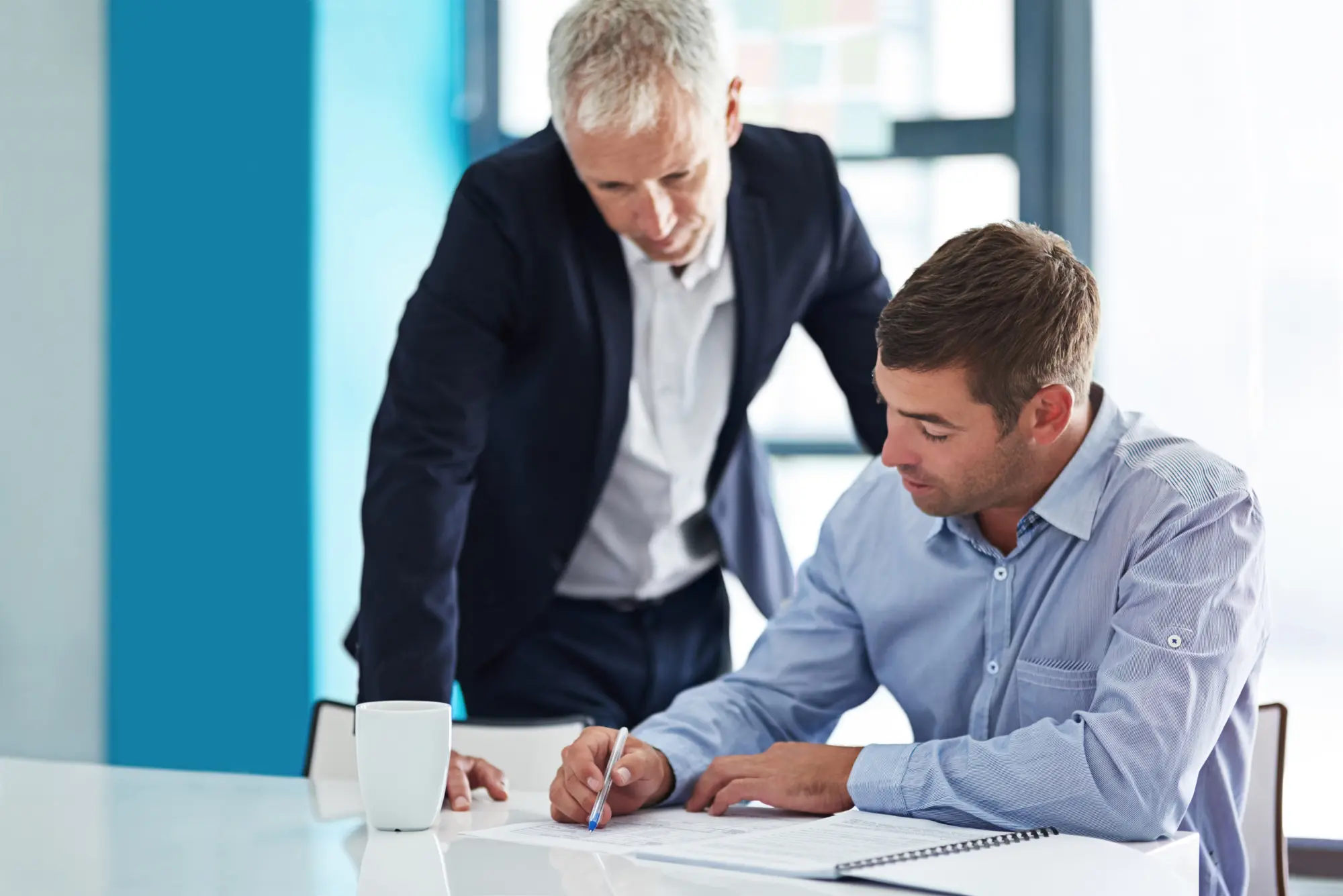 a business founder mentoring his younger successor