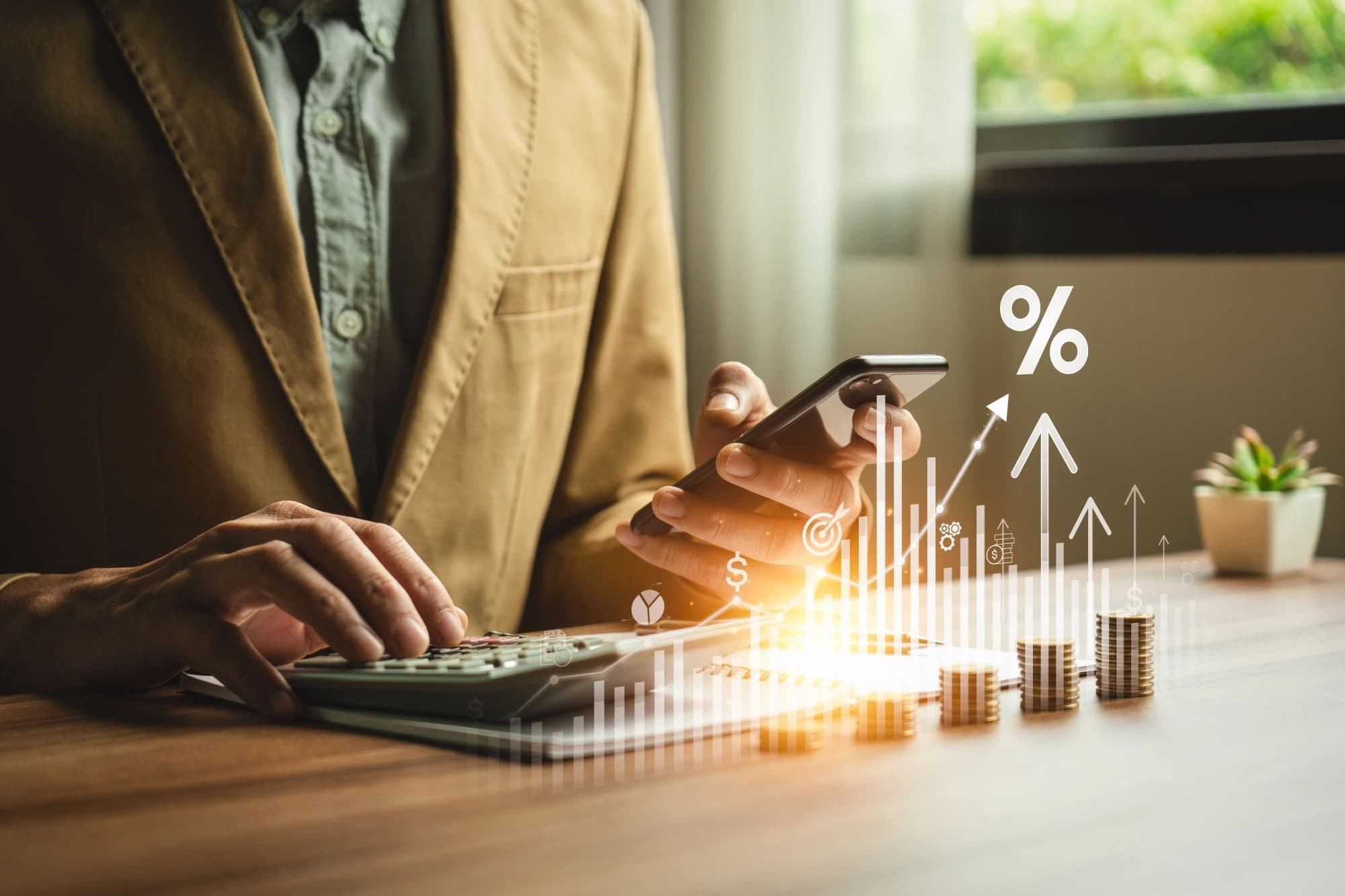 Businessman typing on a calculator overlaid with an image of a graph