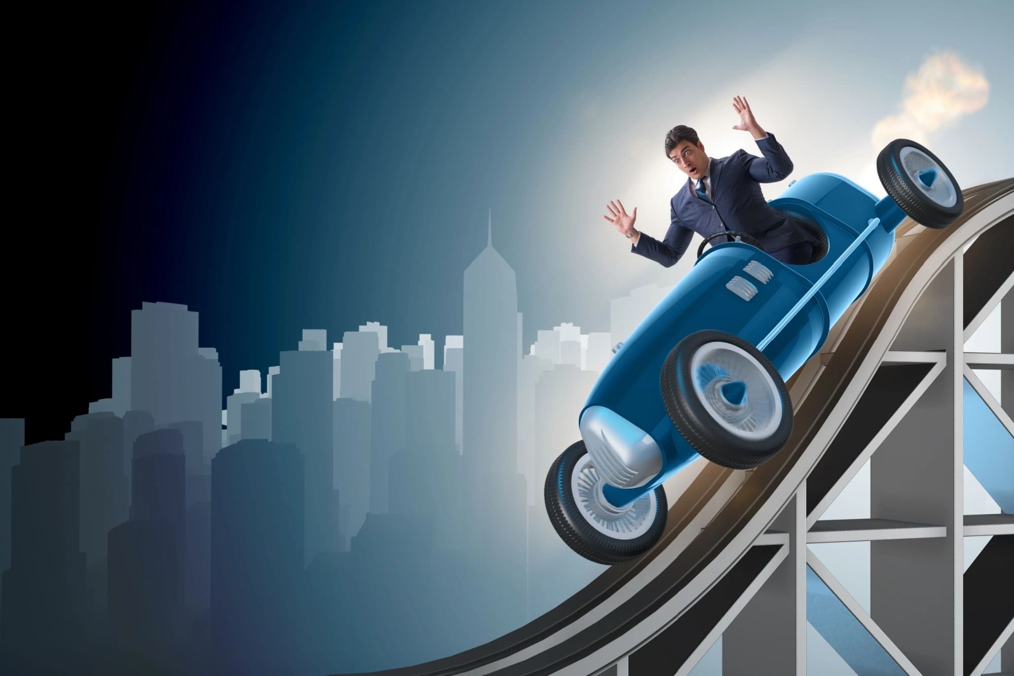 Businessman in a car going down a roller coaster