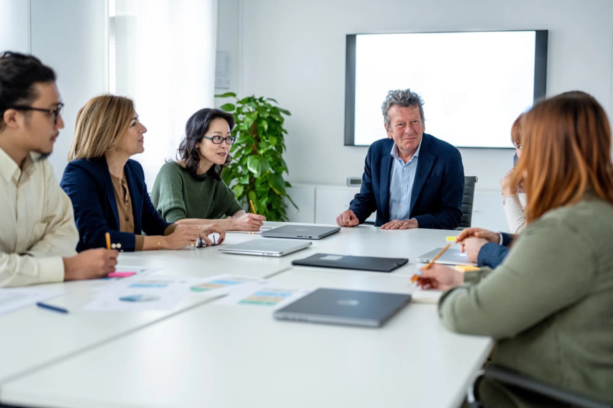 Employees meeting around a conference table to discuss ESOPs