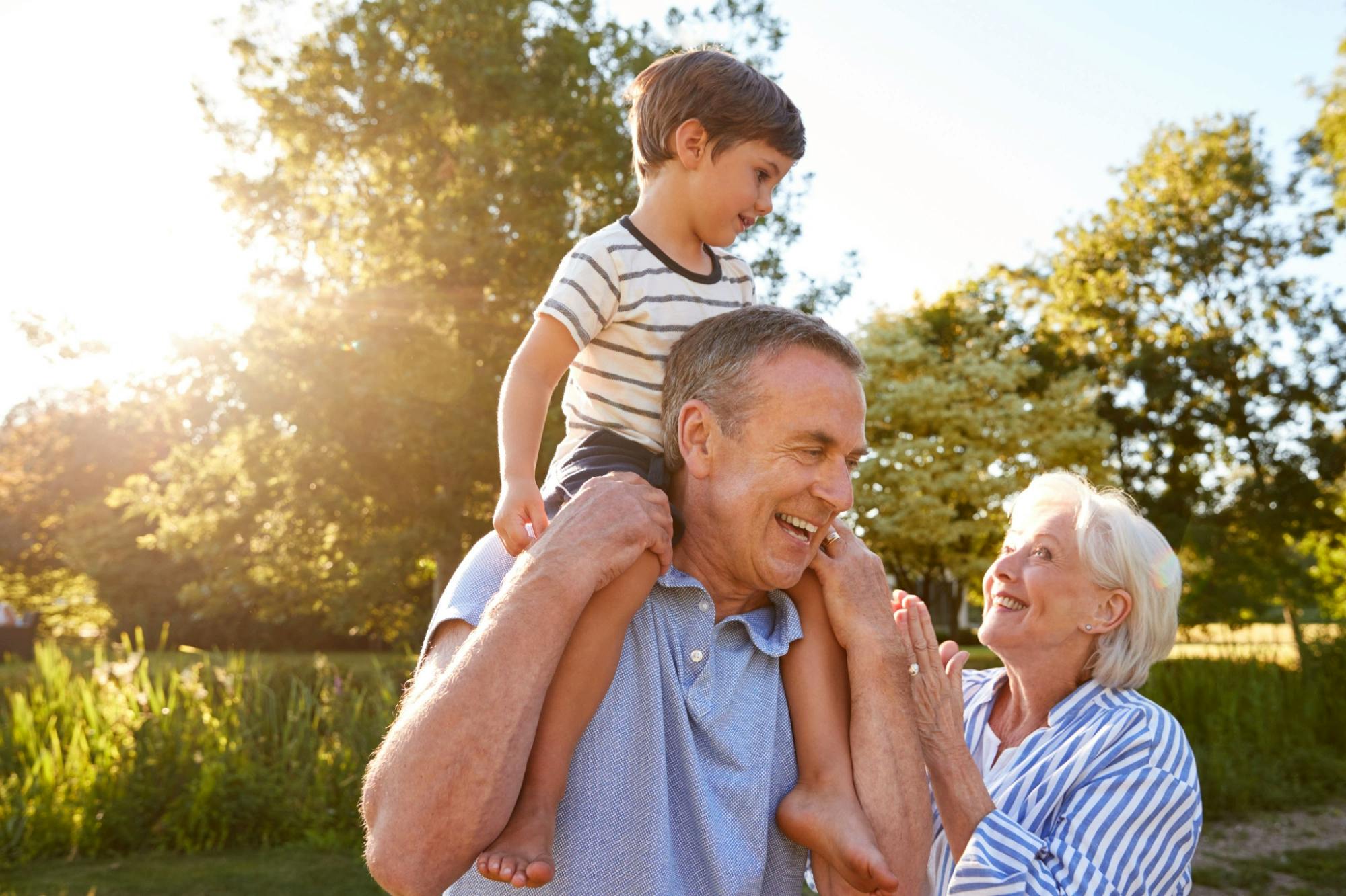 Grandparents playing with their grandson while they discuss avoiding inheritance tax in texas