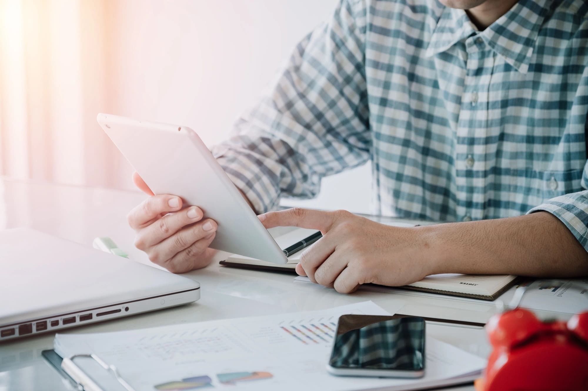 Business person reviewing their year-end tax checklist on their tablet