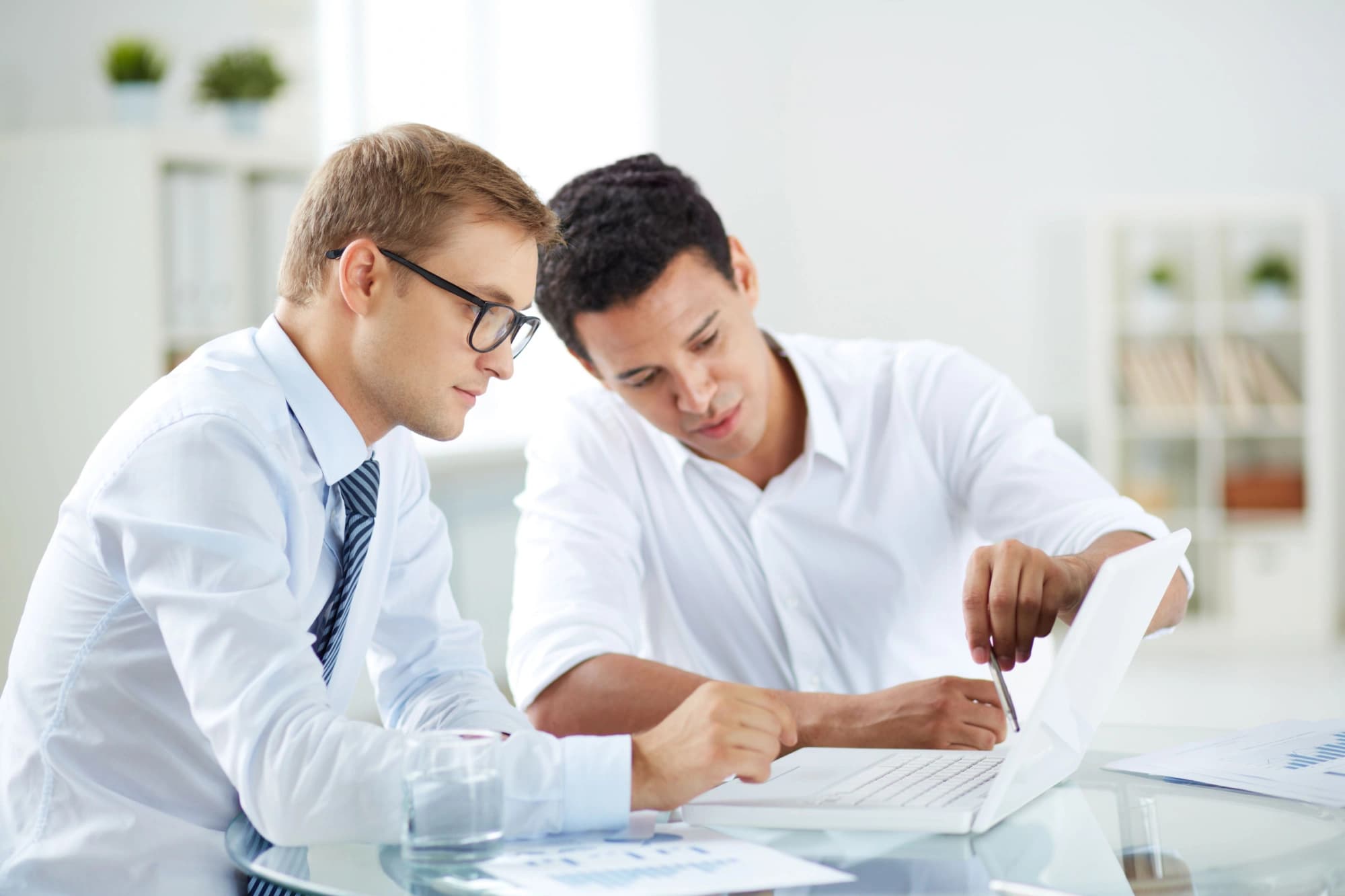 Two wealth business men talking going over their annual financial review