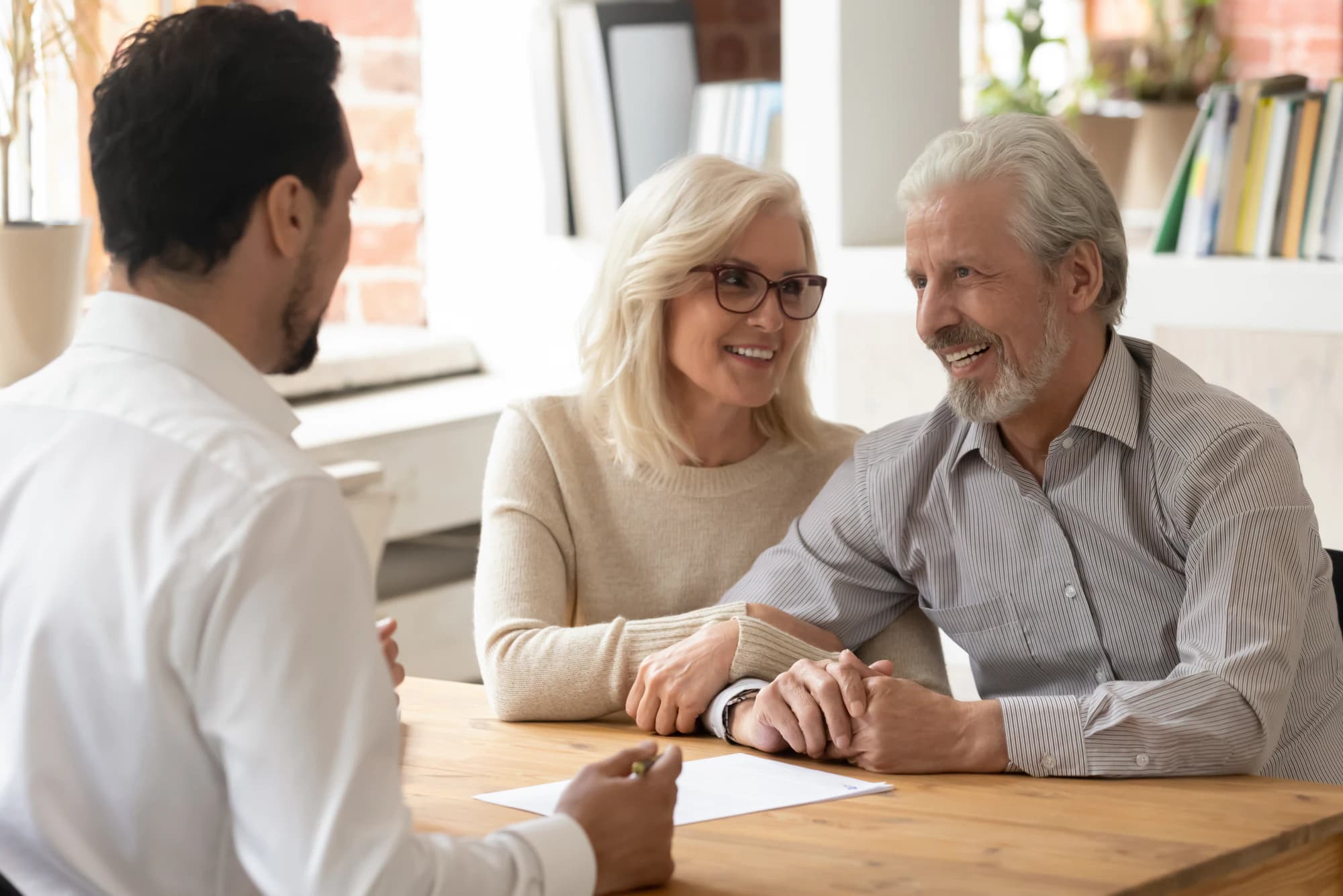 Older couple having a conversation with their financial advisor.