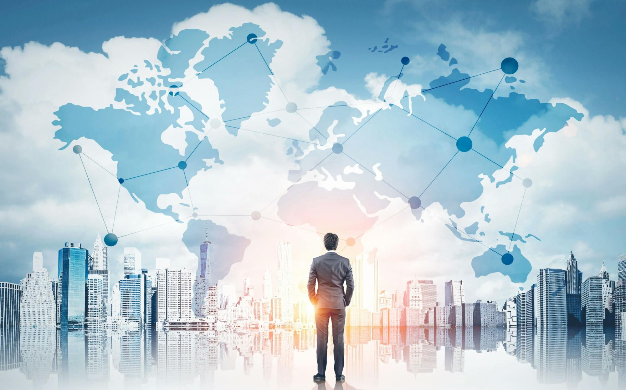 Business man standing in front of a cityscape with a world map laid on top of the image