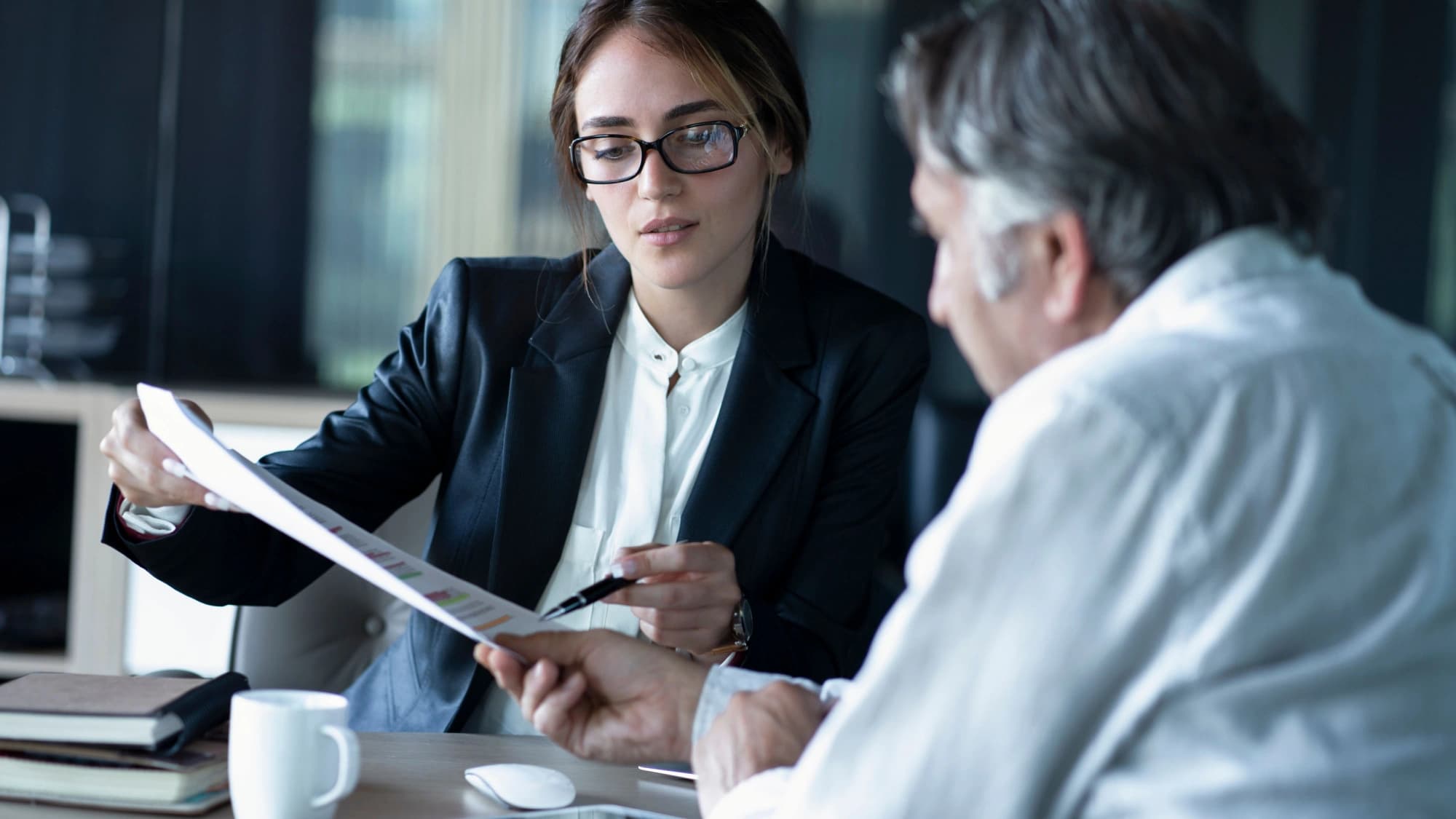 Man and woman looking over his financial plan