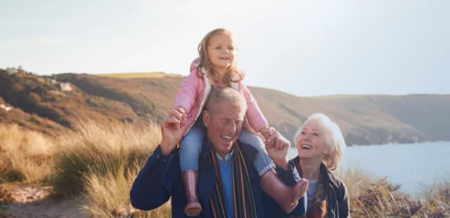 Grand parents hiking with grand daughter