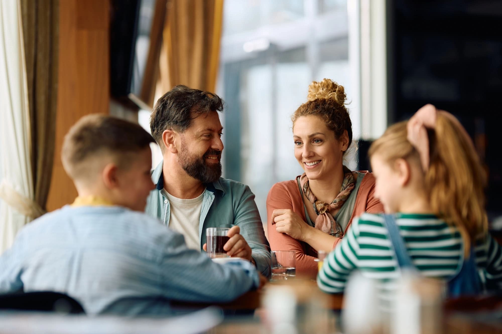 Happy parents talking to their children about wealth