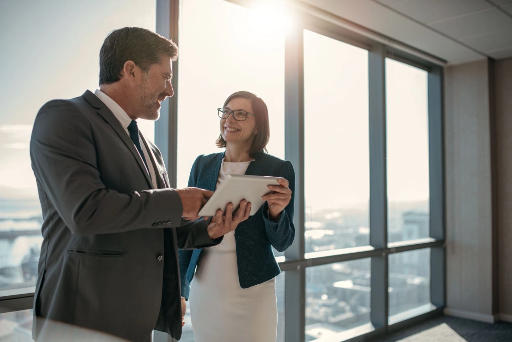 Businessman and woman looking up at their new investment building