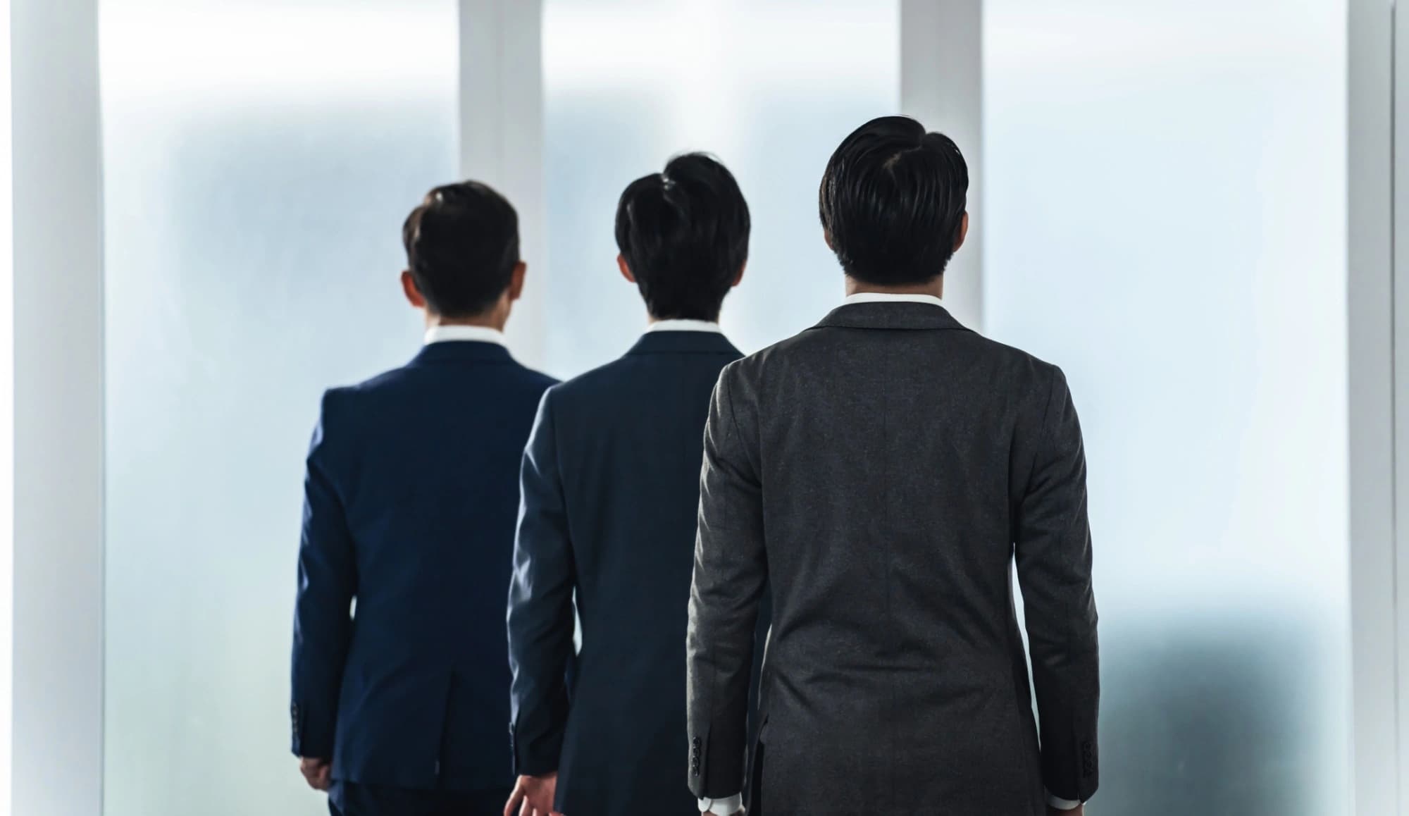 Multi-generational business owners standing in a line backwards