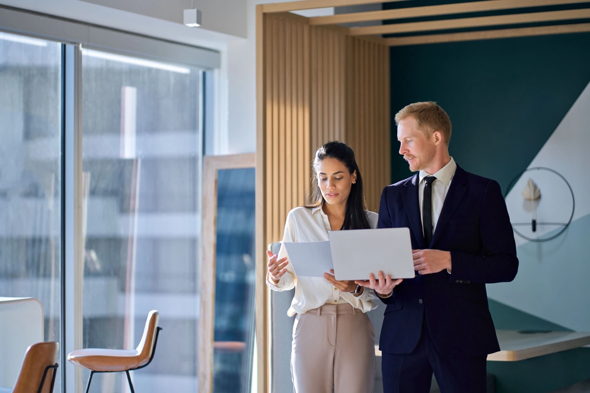 Businessman and woman reviewing projections for interest rates