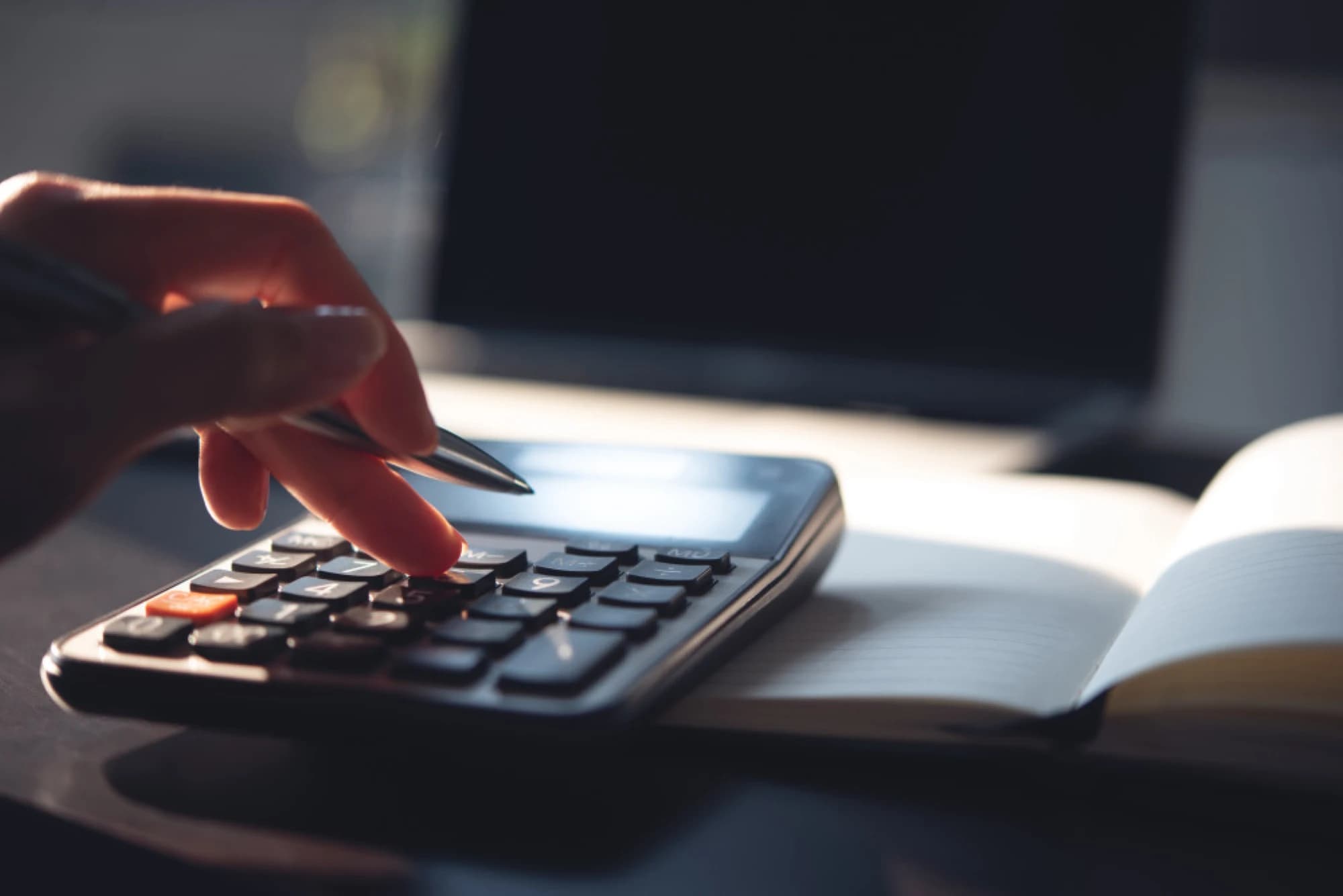 A woman using a calculator for her tax planning