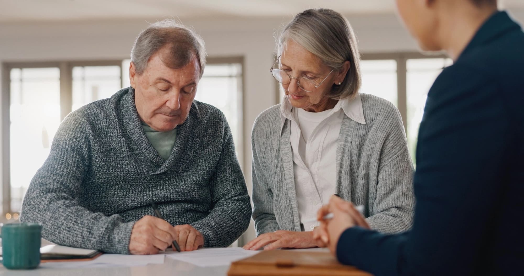 Older unmarried couple talking to an estate planning advisor