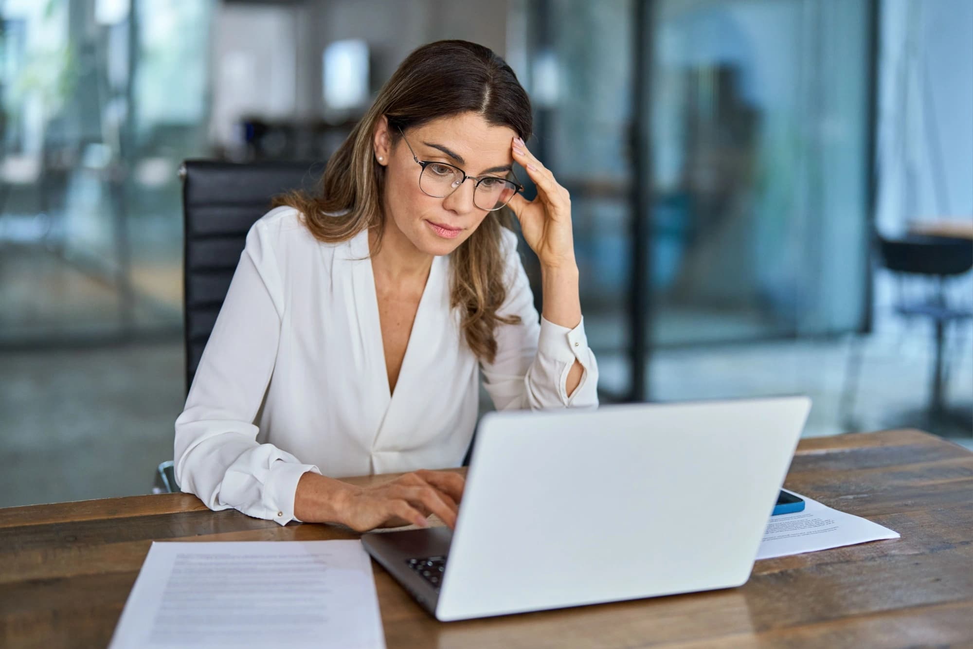 Worried businesswoman looking at her laptop after being audited by the IRS