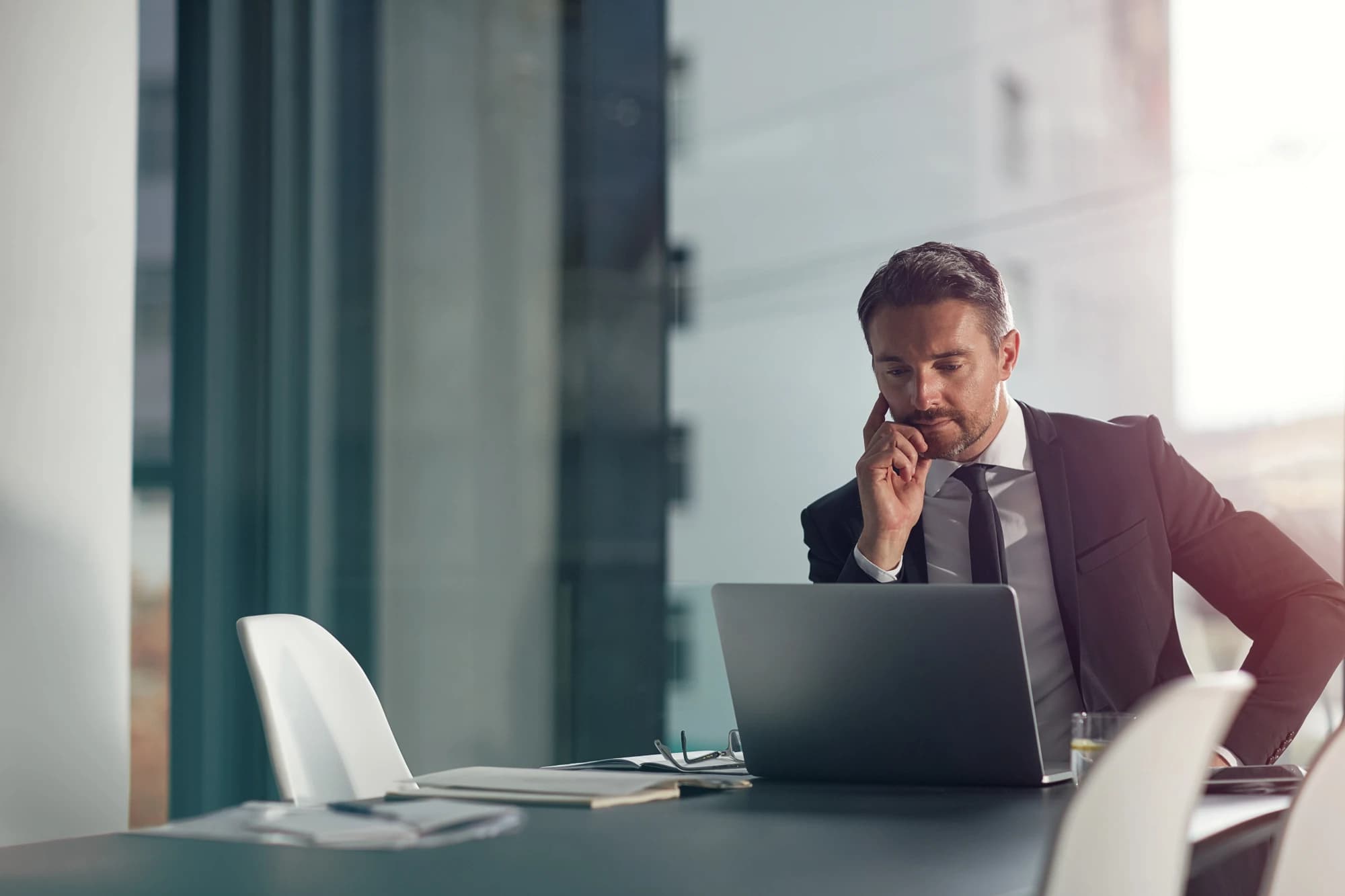 Businessman researching prediction markets on his laptop